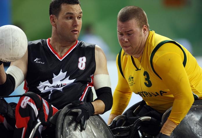 Two male wheelchair rugby players in action